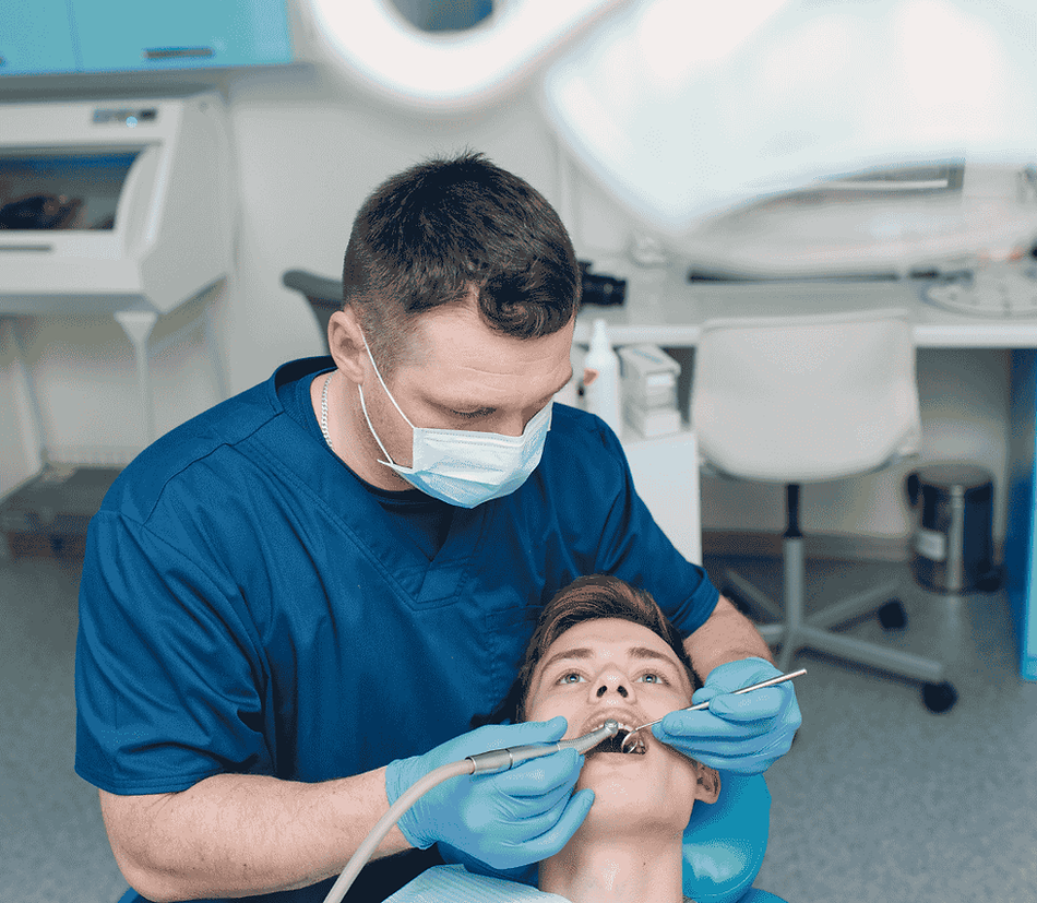 Dentist performing dental bonding procedure on a young patient
