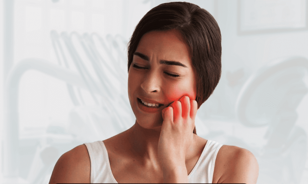 Woman with toothache holding her cheek in pain at a dental clinic