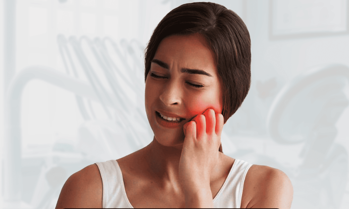 Woman with toothache holding her cheek in pain at a dental clinic